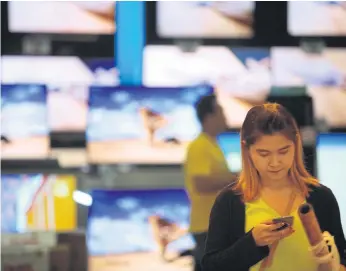  ??  ?? SCREEN ME UP: Shoppers check out TV prices at a fair held in Bangkok. The FPO says VAT, an indicator of domestic consumptio­n, rose by 7.2% in February from a year ago.