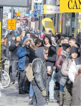  ?? RYAN REMIORZ / THE CANADIAN PRESS ?? Customers line up at a government cannabis store in Montreal on Thursday, as a surge of interest across the country led to shortages of certain strains of marijuana.