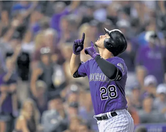  ?? Andy Cross, The Denver Post ?? Nolan Arenado will be trading his purple pinstripes for Cardinals red as the Rockies finalize a deal sending the third baseman to St. Louis.