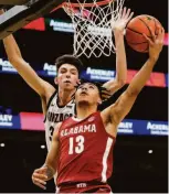  ?? Elaine Thompson / Associated Press ?? Alabama’s Jahvon Quinerly shoots as Gonzaga’s Chet Holmgren defends during the Crimson Tide’s win in Seattle.