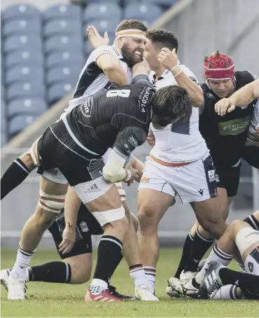  ??  ?? 0 Edinburgh’s Nick Haining, in headband, clashes with Glasgow Warriors’ Ryan Wilson at Murrayfiel­d.