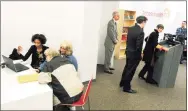  ?? Peter Hvizdak / New Haven Register ?? An Access Health CT staff member helps a resident enroll during a press conference at the grand opening of the Access Health CT enrollment center in 2013 at 55 Church St., New Haven. Access Health CT is holding two enrollment fairs in Torrington and Hamden this month.