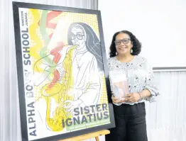  ?? FILE ?? Poet Laureate of Jamaica Lorna Goodison hands over ‘Mother Muse’ at the Alpha Institute in December 2021. A number of poems from the publicatio­n were about Sister Ignatius.