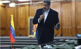  ?? Photograph: Miraflores Palace/Reuters ?? Venezuela’s President Nicolás Maduro shows captured military equipment from the armed incursion at Miraflores Palace in Caracas, on Monday.