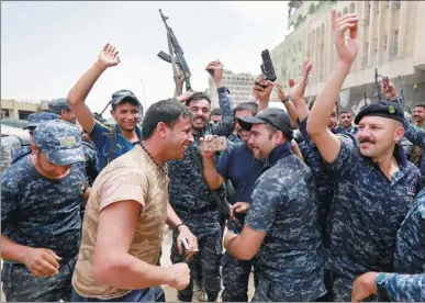  ?? AHMED SAAD/ REUTERS ?? Iraqi police celebrate in the Old City of Mosul, Iraq. A US-trained elite Iraqi force battling Islamic State in the Old City of Mosul on Sunday reached the Tigris riverbank, state TV said, indicating that the insurgents’ last redoubt in the city was on...