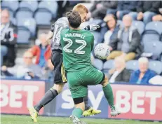  ??  ?? Preston keeper Chris Maxwell fouls Watmore but avoided a red card.