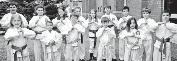  ?? [ELENA MAYSTRUK / THE OBSERVER] ?? Seventeen Elmira students came away with awards in the black belt, blue brown belt, green belt, yellow orange belt, white belt and peewee belt categories.