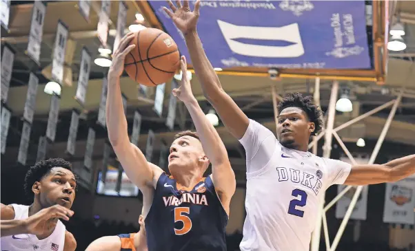  ??  ?? On Jan. 19 at Cameron Indoor Stadium in Durham, Duke and forward Cam Reddish handed Virginia and guard Kyle Guy its first loss, 72-70. ROB KINNAN, USA TODAY SPORTS