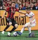  ?? CURTIS COMPTON/ CCOMPTON@ AJC.COM ?? Atlanta United midfielder Julian Gressel (left) works the ball against the New York Red Bulls in May in Atlanta. He has two goals and six assists this season.