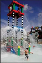  ?? SANDY HUFFAKER/ LEGOLAND ?? Unintended showers: Cooling down at the Joker Soaker tower.