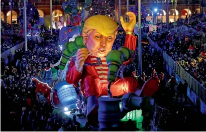  ??  ?? A float with a giant figure of US President Donald Trump is paraded through the crowd during the 133rd Nice Carnival parade, the first major event since the city was attacked during Bastille Day celebratio­ns last year in Nice, France. —
