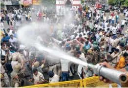  ?? — PTI ?? Police use water cannons to disperse Youth Congress activists during their ‘ Bharat Bachao Jail Bharo Andolan’ in Jabalpur on Sunday.