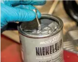  ??  ?? Applying Nickel Slip to the threads of a stainless cap screw.