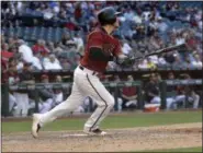  ?? MATT YORK — ASSOCIATED PRESS ?? Diamondbac­ks’ Chris Herrmann watches the flight of his game-winning homer in the 11th inning of the Mets’ 5-4 loss in Phoenix on Wednesday.