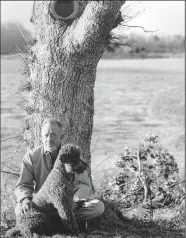  ?? NATIONAL PORTRAIT GALLERY/COURTESY PHOTOGRAPH ?? American novelist John Steinbeck appears with his pet poodle Charley in a tranquil moment from 1961.