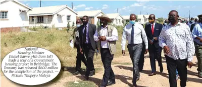  ?? — ?? National Housing Minister Daniel Garwe (4th from left) leads a tour of a Government housing project in Beitbridge. The Treasury has released $600 million for the completion of the project. Picture: Thupeyo Muleya