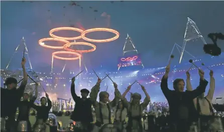  ??  ?? FIVE-RING CIRCUS: Drummers give it stick during the opening ceremony of the London 2012 Olympic Games