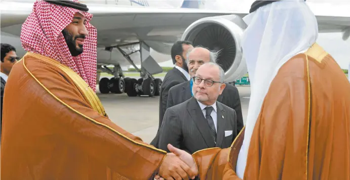  ??  ?? Saudi Arabia’s Crown Prince Mohammed bin Salman(left) is greeted by Argentina’s foreign minister Jorge Faurie (centre) and an embassy official on his arrival in Buenos Aires this week for the G20 summit.