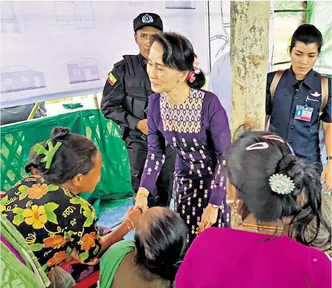  ??  ?? Aung San Suu Kyi meets with Myo ethnic people in Maungdaw on her first visit to conflict-battered northern Rakhine State, an area that has seen most of its Rohingya Muslims flee