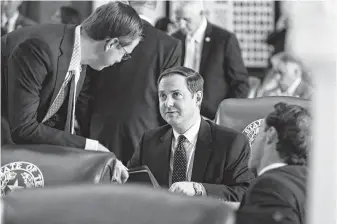  ?? James Gregg / Associated Press ?? Dustin Burrows of Lubbock, center, shown talking with fellow GOP Rep. Will Metcalf of Conroe, left, resigned as chair of the Texas House GOP Caucus.