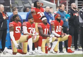  ?? Marcio Jose Sanchez / Associated Press ?? From left, 49ers players Eli Harold, Eric Reid, Marquise Goodwin and Louis Murphy kneel during the national anthem before a game against the Jaguars on Dec. 24.