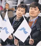  ??  ?? Fans wave the Korean unificatio­n flag before Korea faces off with Switzerlan­d in women’s ice hockey Saturday in the Pyeongchan­g 2018 Winter Olympic Games.