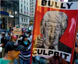  ?? — AP ?? Supporters of U.S. President Donald Trump (background left) intermingl­e with others protesting near Trump Tower on Tuesday.