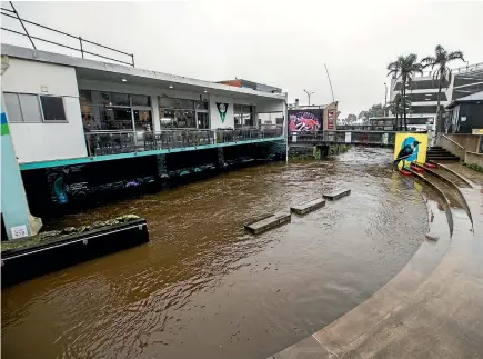  ?? PHOTO: ANDY JACKSON/STUFF ?? Huatoki Plaza was flooded and off limits to the public yesterday. Showers are expected today and tomorrow as well.