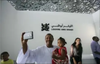  ?? KAMRAN JEBREILI — THE ASSOCIATED PRESS ?? Jalal Bushra Al Fadal from Sudan takes a selfie, during the public opening day Louvre Museum, in Abu Dhabi, United Arab Emirates, Saturday. of the