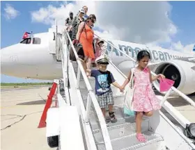  ?? AP FILE PHOTO ?? Passengers arrive in Cienfuegos, Cuba, from Miami in September.