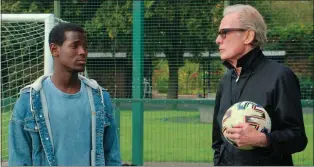  ?? COURTESY OF NETFLIX ?? Micheal Ward, left, and Bill Nighy share a scene from “The Beautiful Game.”