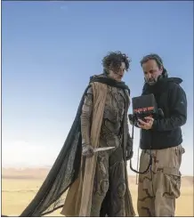  ?? Niko Tavernise / Warner Bros. Pictures photo via AP ?? Director Denis Villeneuve (right), with actor Timothee Chalamet on the set of “Dune: Part Two” is shown in this image.