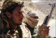  ?? JON GAMBRELL — THE ASSOCIATED PRESS ?? In this Friday photo, Yemeni militiamen allied to the country’s internatio­nally recognized government prepare to climb a mountain in the outskirts of Sanaa, Yemen. Yemen’s conflict, which began as a civil war in 2014 and escalated into a regional proxy...