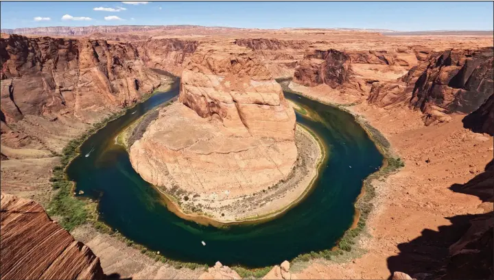  ?? BRITTANY PETERSON / AP (2022) ?? The Colorado River f lows at Horseshoe Bend in the Glen Canyon National Recreation Area in Page, Ariz. With Western states mired in its worst drought in more than 1,200 years, elected officials in the region are rethinking how groundwate­r is used and who gets access to it. Some politicans are targeting foreign-owned companies.