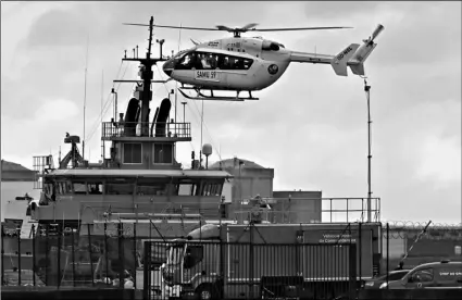  ?? AP Photo ?? A French rescue helicopter lands close to a rescue vessel in Dunkirk, northern France, on Tuesday, during a search operation after four migrants, including a 5-year-old and 8-year-old child died Tuesday when their boat capsized while they and other migrants tried to cross the English Channel to Britain, French authoritie­s said.