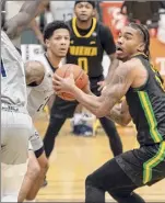  ?? James Franco / Special to the Times Union ?? Siena senior Manny Camper looks for room in front of St. Peter’s sophomore Hassan Drame. Camper finished with 12 points for the Saints.