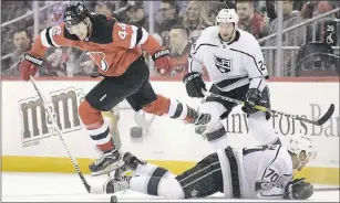  ?? BILL KOSTROUN — ASSOCIATED PRESS ?? The Devils’ Miles Wood (44) leaps over the Kings’ Tanner Pearson (70) as Derek Forbort looks on during the first period of New Jersey’s 5-1 victory on Tuesday.