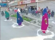  ?? ANI ?? Srinagar MC employees maintain social distancing outside a Jammu and Kashmir Bank branch in Srinagar on Saturday.