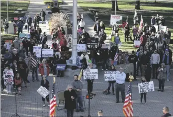  ?? AP PHOTO/JOHN HANNA ?? Opponents of COVID-19 vaccine mandates rally outside the Kansas Statehouse, on Saturday in Topeka, Kan.