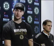  ?? ELISE AMENDOLA - THE ASSOCIATED PRESS ?? Boston Bruins defenseman Brandon Carlo speaks, as General Manager Don Sweeney listens during a news conference at the hockey team’s practice facility, Tuesday, Sept. 17, 2019, in Boston. The Bruins have signed Carlo to a two-year contract with an annual NHL cap hit of $2.85 million.