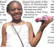  ??  ?? Kianna Walch, 6, of Brampton, holds up a pink model car her parents bought her at the Honda Indy.