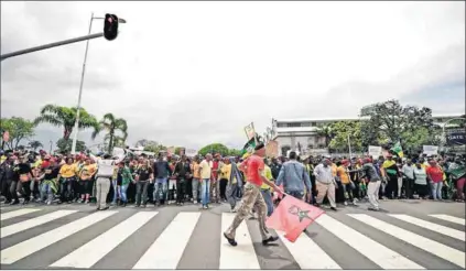  ?? Photo: Tebogo Letsie/Gallo Images/City Press ?? Crossing the line: Disgruntle­d ANC members march to the party’s offices in Durban late last year.