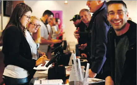  ?? DARREN MAKOWICHUK ?? Happy customers place their orders at the Premium Four20 Market in Calgary on Wednesday.