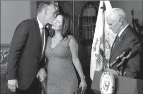  ?? AP/ANDREW HARNIK ?? New Interior Secretary Ryan Zinke kisses his wife, Lolita Hand, after he was sworn in Wednesday by Vice President Mike Pence at the Eisenhower Executive Office Building in Washington.