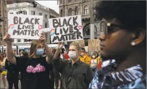  ?? Peter Dejong / Associated Press ?? People take part in a Black Lives Matter to protest against the recent killing of George Floyd, a black man who died in police custody in Minneapoli­s.