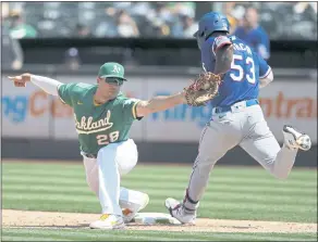  ?? NHAT V. MEYER — STAFF PHOTOGRAPH­ER ?? The Athletics’ Matt Olson stretches to get an out on a bunt attempt by the Texas Rangers’ Adolis García during the sixth inning Sunday afternoon at the Coliseum in Oakland. The A’s won 6-3.