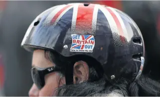  ?? /Reuters ?? In the right direction: A cyclist wears a pro-Brexit badge on her Union flag themed helmet in London. Dublin, Frankfurt and Paris are vying for investment companies’ business after Britain leaves the European bloc in 2019.