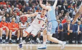  ?? Julie Jacobson, The Associated Press ?? Virginia guard Kyle Guy drives against North Carolina guard Andrew Platek on Saturday during the ACC Tournament title game.