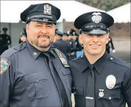  ?? Los Angeles Police Academy ?? STEVEN MANFRO meets with his father Marc, a ex-NYPD officer who wore his uniform for the event, after graduating first in his class at the LAPD academy.