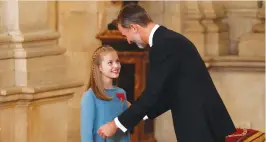  ?? (AFP) ?? Spain’s King Felipe VI (right) awards his country’s most prestigiou­s award, the Order of the Golden Fleece to his daughter Princess Leonor, 12 year old heir to the throne, in Madrid on Tuesday